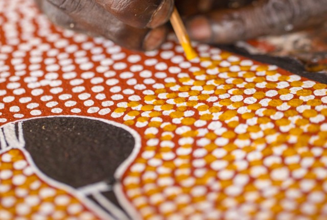 close up of aboriginal artist painting