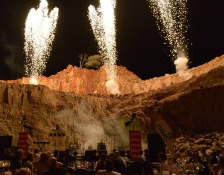 Outdoor function with fireworks going off in background 