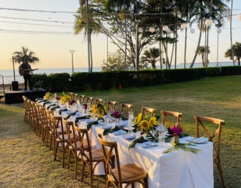 Outdoor event with set dining table 