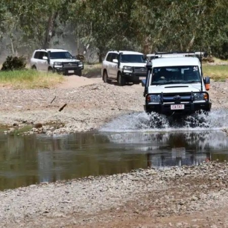 4WD vehicle driving across river 