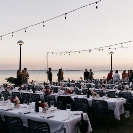 Outdoor function space with set tables at Pee Wees at the Point