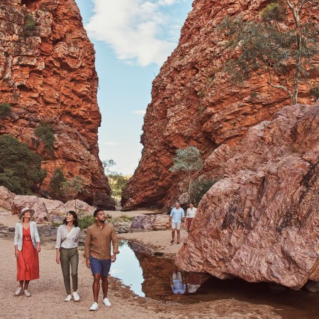 Group of people walking through Simpsons Gap Lookout 