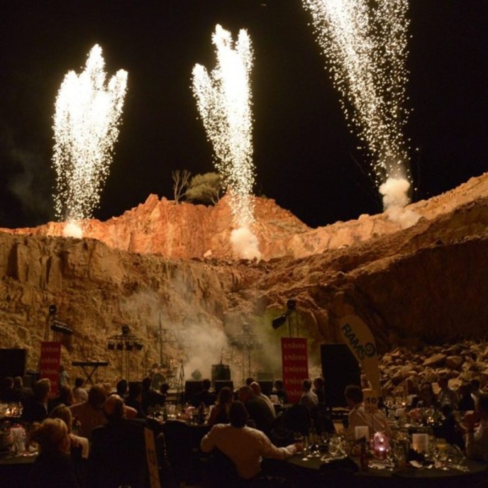 Outdoor function with fireworks going off in background 