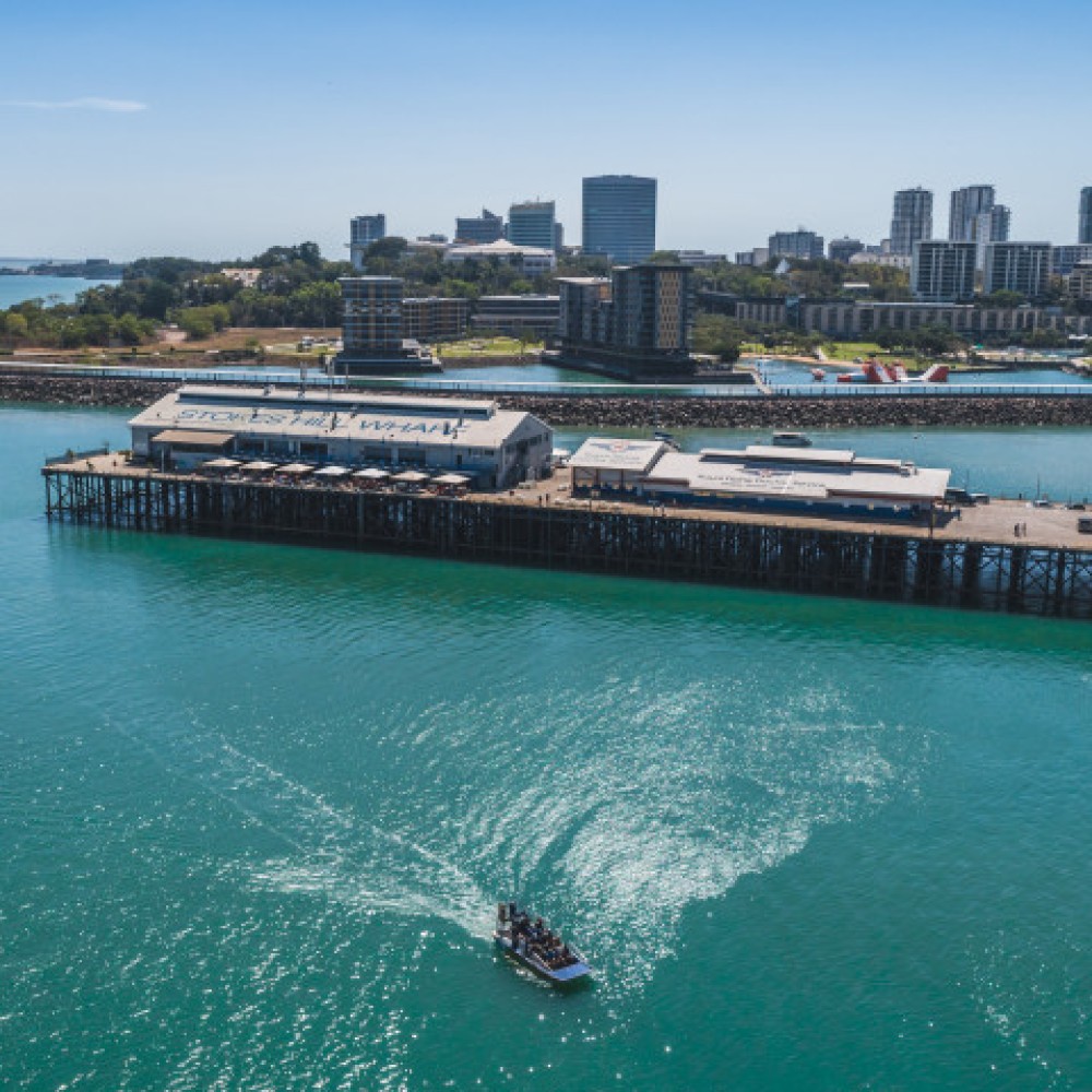 Ariel view of airboat on Darwin Harbour with Stokes Hill Wharf in the background